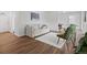 Bright living room with white sofa, green chairs, and adjacent dining area at 1195 S Kendall St, Lakewood, CO 80232