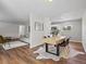 Open floor plan with modern dining table and chairs, and living room with comfortable sofa and rug at 1195 S Kendall St, Lakewood, CO 80232