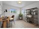 Bright office with a desk, shelving, neutral decor and natural light from two windows at 1195 S Kendall St, Lakewood, CO 80232