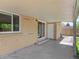 A covered patio with brick, concrete, and a sliding glass door at 1195 S Kendall St, Lakewood, CO 80232