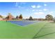 Well-maintained green and blue tennis courts surrounded by fencing and greenery for recreational play at 1195 S Kendall St, Lakewood, CO 80232