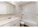 Updated bathroom features white marble tile, a shower over tub, and a vanity at 7700 W Glasgow Pl # 24C, Littleton, CO 80128