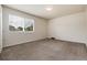 A light and bright bedroom with neutral carpet and paint, and a large window at 7700 W Glasgow Pl # 24C, Littleton, CO 80128