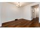 Bright dining area showcasing modern light fixture, sleek flooring, and adjacent access ways at 7700 W Glasgow Pl # 24C, Littleton, CO 80128
