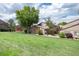 View of townhomes with lawn space and mature shade trees on a sunny day at 7700 W Glasgow Pl # 24C, Littleton, CO 80128