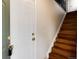 Open entryway featuring wood stairs with metal railings and a glimpse of the interior layout at 7700 W Glasgow Pl # 24C, Littleton, CO 80128