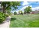 Scenic view of the well-maintained community grounds with lush green lawns and mature trees at 7700 W Glasgow Pl # 24C, Littleton, CO 80128