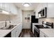 Efficient kitchen featuring stainless steel appliances, modern countertops, and ample cabinet space at 7700 W Glasgow Pl # 24C, Littleton, CO 80128