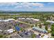 Expansive aerial view of a shopping center featuring a large parking lot and green landscaping at 9442 W Walden Ave, Littleton, CO 80128
