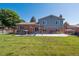 Large backyard featuring a patio, wooden pergola, and a well-manicured lawn at 9442 W Walden Ave, Littleton, CO 80128