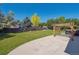 Spacious backyard featuring well maintained lawn, patio, pergola, privacy fence, and mature trees at 9442 W Walden Ave, Littleton, CO 80128