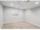 Finished basement space with neutral colored carpet and a window at 9442 W Walden Ave, Littleton, CO 80128