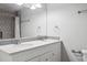 Bright bathroom featuring double sink vanity, modern fixtures, and shower with gray tile at 9442 W Walden Ave, Littleton, CO 80128