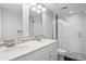 Modern bathroom featuring double sinks, a shower and a tiled floor at 9442 W Walden Ave, Littleton, CO 80128