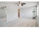 Carpeted bedroom with a ceiling fan, large window and closet with mirrored doors at 9442 W Walden Ave, Littleton, CO 80128