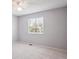 Bedroom featuring a window, a ceiling fan and neutral carpeting at 9442 W Walden Ave, Littleton, CO 80128