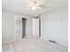 Bright carpeted bedroom with ceiling fan and mirror closet doors at 9442 W Walden Ave, Littleton, CO 80128