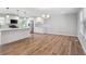 Open floor plan shows kitchen with white cabinets, island and stainless steel appliances at 9442 W Walden Ave, Littleton, CO 80128