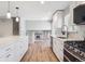 Modern kitchen featuring white cabinets, stainless steel appliances, and an open floorplan at 9442 W Walden Ave, Littleton, CO 80128