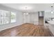 Open concept living room with stairs, hardwood floors, a front door, and window views at 9442 W Walden Ave, Littleton, CO 80128