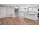 Open floor plan of the living room, showcasing stairs, kitchen, hardwood floors, and a chandelier at 9442 W Walden Ave, Littleton, CO 80128
