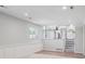 Bright living room featuring wainscoting, wood floors, and an open concept view to the kitchen at 9442 W Walden Ave, Littleton, CO 80128