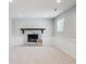 Cozy living room with a brick fireplace and mantle, wainscoting, and neutral carpet at 9442 W Walden Ave, Littleton, CO 80128