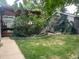 Lush backyard with mature trees, and covered patio, perfect for outdoor living and entertaining at 3098 W 39Th Ave, Denver, CO 80211