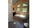 A well-lit bathroom with a soaking tub, a walk-in shower and multiple windows that bring in natural light at 3098 W 39Th Ave, Denver, CO 80211
