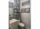 Stylish bathroom featuring tiled walls, floating shelves, and modern fixtures, providing a contemporary and functional space at 3098 W 39Th Ave, Denver, CO 80211
