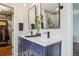 Bathroom featuring double sinks, modern fixtures, and a view into a walk-in closet for added storage at 5362 E 140Th Pl, Thornton, CO 80602
