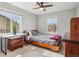 Cozy bedroom features a bed, desk, wood floors, and bright natural light at 5362 E 140Th Pl, Thornton, CO 80602