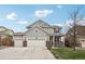 Charming two-story home with a three car garage, inviting porch, and well-maintained landscaping at 5362 E 140Th Pl, Thornton, CO 80602