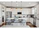 Modern kitchen featuring white cabinets, stainless steel appliances, hardwood floors, and pendant lighting at 5362 E 140Th Pl, Thornton, CO 80602