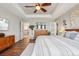 Spacious main bedroom with hardwood floors, tray ceilings, stylish decor, and ample natural light at 5362 E 140Th Pl, Thornton, CO 80602
