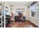 Home office with hardwood floors, natural light, two desks, and decorative shelving at 5362 E 140Th Pl, Thornton, CO 80602
