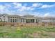 Spacious backyard view featuring a well-manicured lawn and rear patio at 9433 Torrey Way, Arvada, CO 80007