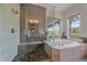 Modern bathroom boasts tiled walk-in shower, tub and scenic views at 9433 Torrey Way, Arvada, CO 80007