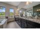 Bathroom with granite countertops, dual sinks, and a beautiful view at 9433 Torrey Way, Arvada, CO 80007