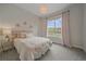 Cozy bedroom with a large window, plush bedding, and neutral decor at 9433 Torrey Way, Arvada, CO 80007