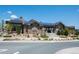 Community center with stone accents, solar panels, and landscaped entrance with walking paths at 9433 Torrey Way, Arvada, CO 80007