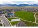 Aerial view of a community park with a pool, playground, sports court, and open green space at 9433 Torrey Way, Arvada, CO 80007