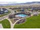 Aerial view of a community pool and playground with surrounding landscaping and walking paths at 9433 Torrey Way, Arvada, CO 80007