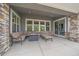 Cozy covered patio area, complete with comfortable seating and fireplace at 9433 Torrey Way, Arvada, CO 80007