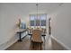 Elegant dining room featuring hardwood floors, high ceilings, and sophisticated chandelier lighting at 9433 Torrey Way, Arvada, CO 80007