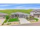 Beautiful single-Gathering home featuring a three-car garage and manicured landscaping with natural backdrop at 9433 Torrey Way, Arvada, CO 80007