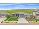 Beautiful single-Gathering home featuring a three-car garage and manicured landscaping with natural backdrop at 9433 Torrey Way, Arvada, CO 80007
