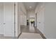 Bright hallway with hardwood floors leads to an open living space with ample natural light at 9433 Torrey Way, Arvada, CO 80007