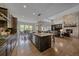 Open-concept kitchen with a large island, a dining area and view to the living room with fireplace at 9433 Torrey Way, Arvada, CO 80007