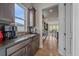 Gourmet kitchen featuring dark wood cabinets and modern appliances with view to the dining area at 9433 Torrey Way, Arvada, CO 80007